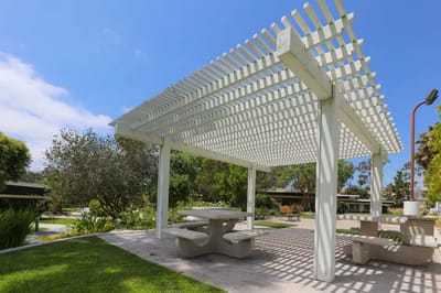 Outdoor shaded seating area with picnic tables