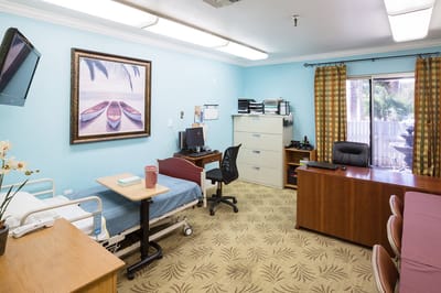 Private resident room with hospital bed and office space