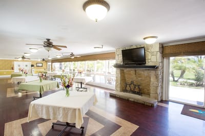 Bright common area with tables and flowers for an event