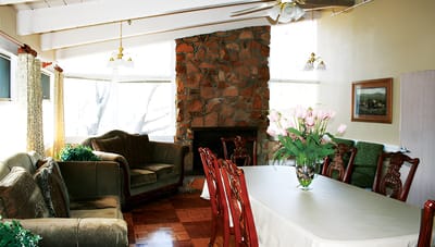 Common area with seating and fireplace in a senior facility