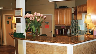 Reception area with a floral arrangement and wooden cabinetry