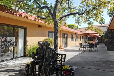 Outdoor courtyard with seating and a statue