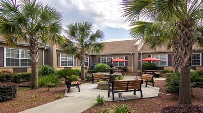 A serene outdoor courtyard with seating and palm trees