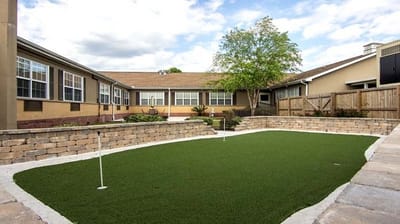 Well-maintained outdoor green space with putting area