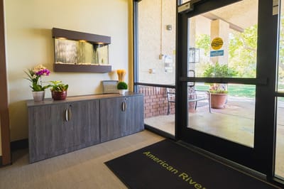 Bright lobby area with a fish tank and plants
