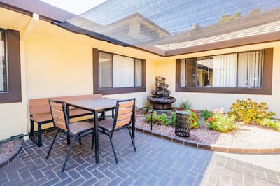Outdoor courtyard with a table and fountain