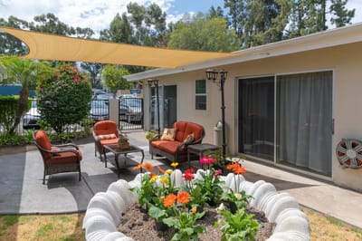Outdoor seating area with flowers and shade