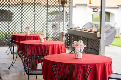 Outdoor dining area with round tables and floral centerpieces