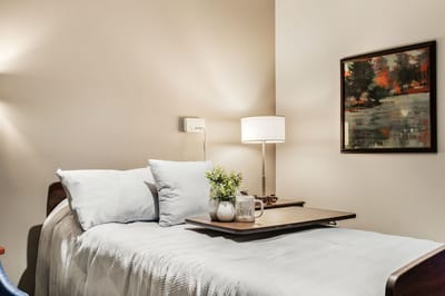 Cozy resident room with bed and lamp