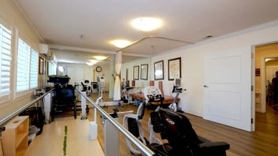 Rehabilitation gym with exercise equipment and therapy spaces