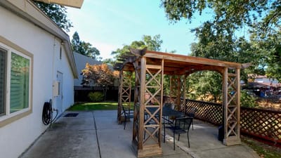 Outdoor seating area with pergola and tables