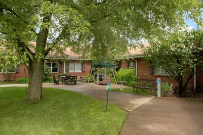 Outdoor space with benches and trees in a nursing home