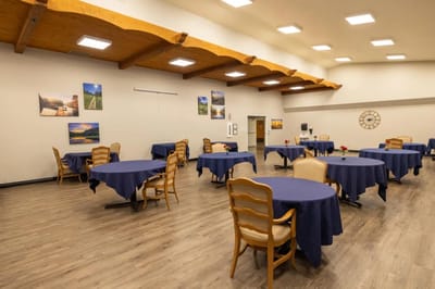 Interior dining area with tables set for residents