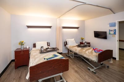 Double occupancy resident room with beds and flowers