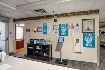 Reception area with signage and kiosk for check-in