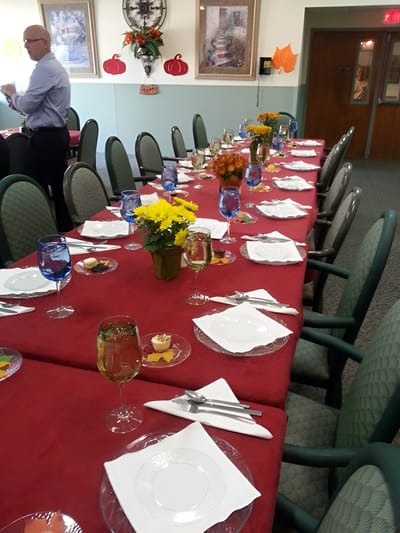 Dining setup for a gathering with decorated tables