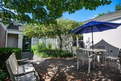 Outdoor seating area with a table and blue umbrella