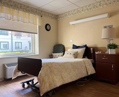 A well-furnished private resident room with bright lighting