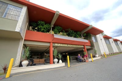 Entrance of Burbank Rehabilitation Center with residents outside