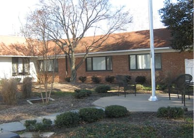 Outdoor seating area with trees and shrubs