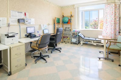 Bright interior of a therapy room with equipment and windows
