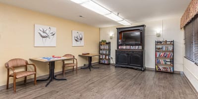 Bright interior common area with tables and shelves