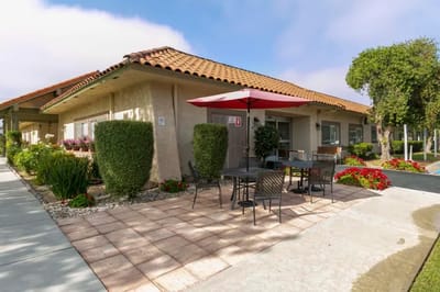 Outdoor seating area with flowers and landscaping