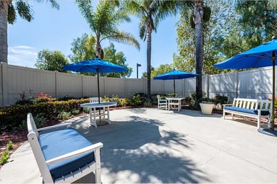 Outdoor seating area with umbrellas and landscaping