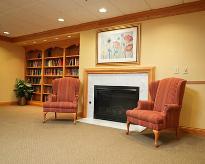 Cozy common area with armchairs and a fireplace