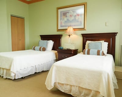 A cozy resident room with twin beds and decor