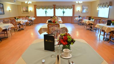 Dining room set for a meal with floral decorations