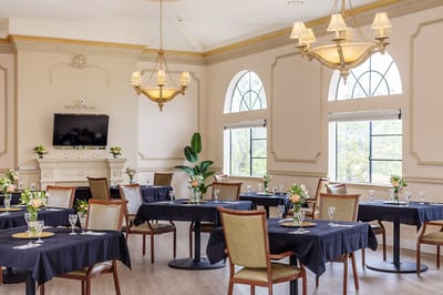 Elegant dining room with tables set for meals