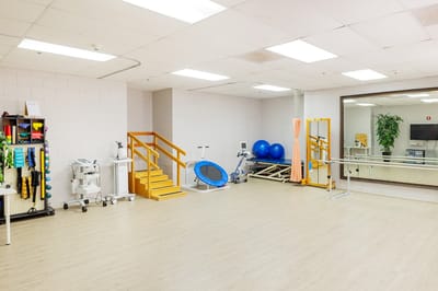 Rehabilitation room with exercise equipment and therapy tools
