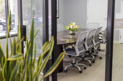 Conference room with a large table and floral centerpiece