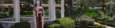 Garden area with a statue and blooming flowers