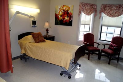 A well-furnished resident room with a flower painting