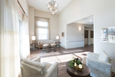 Bright common area with seating and lighting fixtures