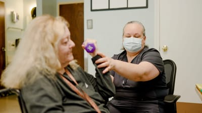 Resident engaging in physical therapy with staff member