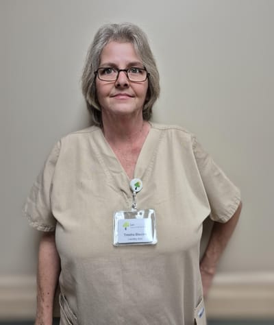 Staff member in uniform with name badge