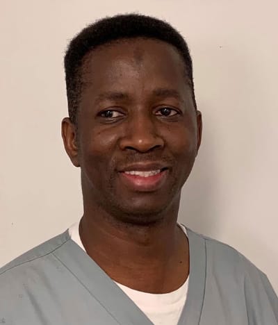 Smiling staff member in scrubs