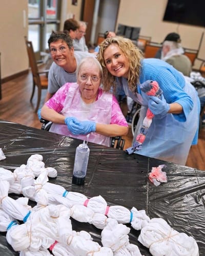 Residents and staff engaged in a tie-dye activity
