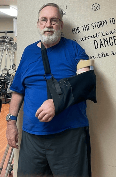 Man with arm in sling in common area