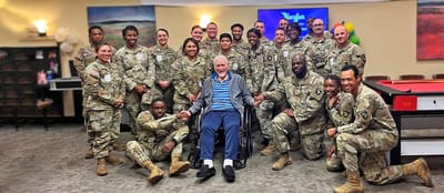 Group of Soldiers with a resident in a common area