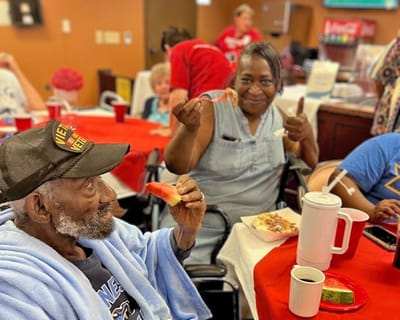 Residents enjoying a meal and smiling together