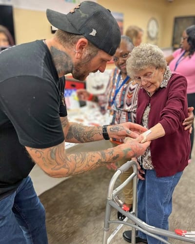 Resident receiving care with staff assistance.