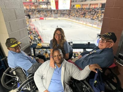 Residents and staff enjoying a hockey game together.