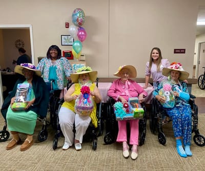 Residents celebrating with gift baskets in a common area