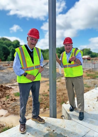 Two men in hard hats at a construction site