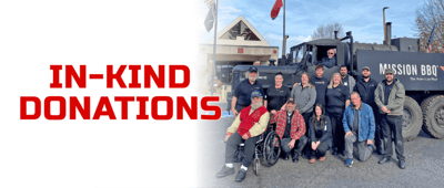 Group photo outside the facility with veterans and staff.