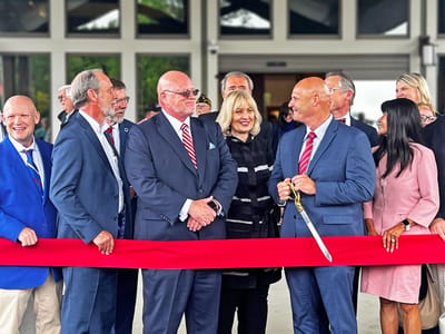 Ribbon-cutting ceremony with attendees